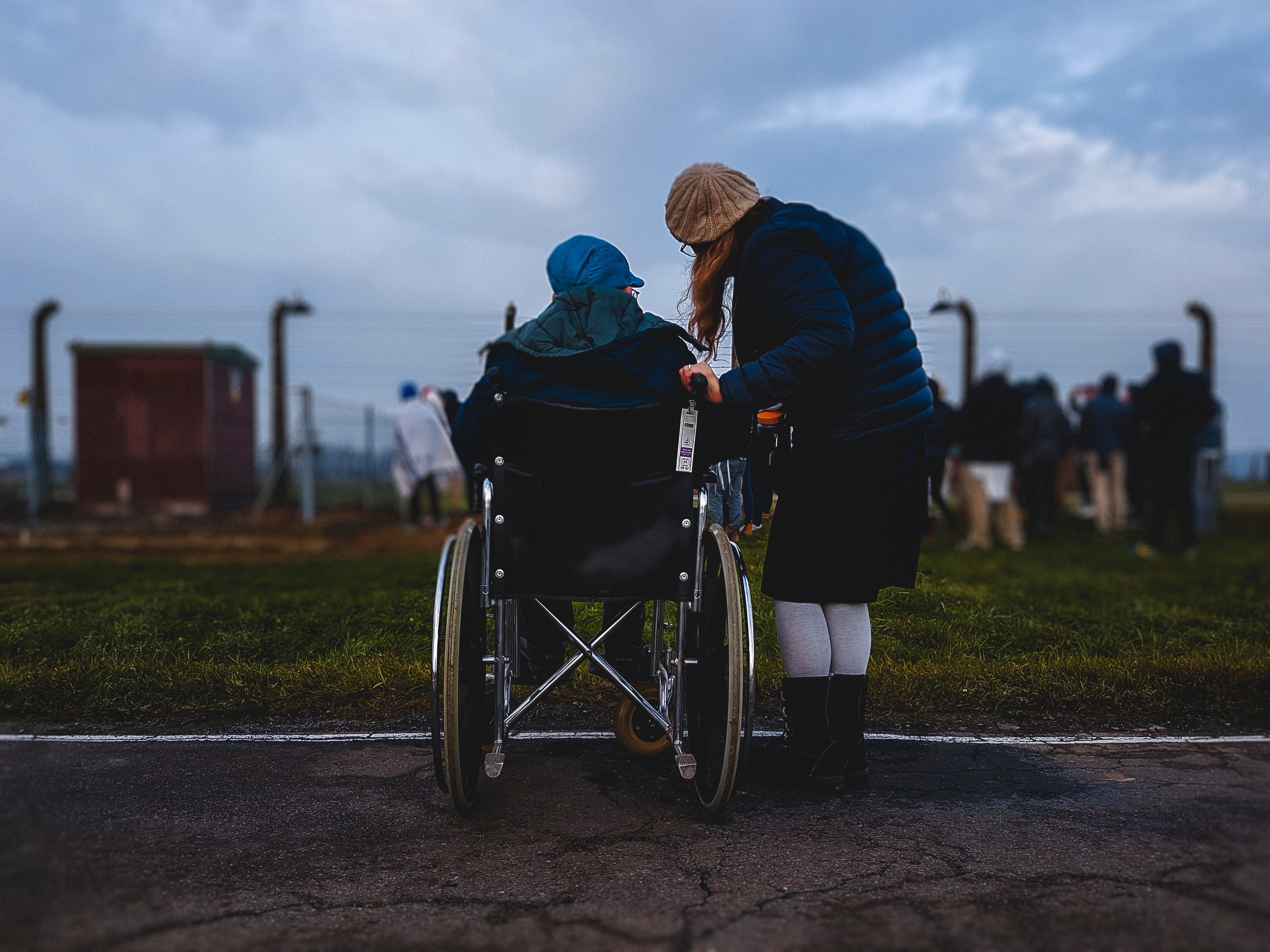 a young person next to an older person in a wheelchair