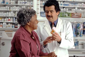 A lady speaking to the  pharmacist