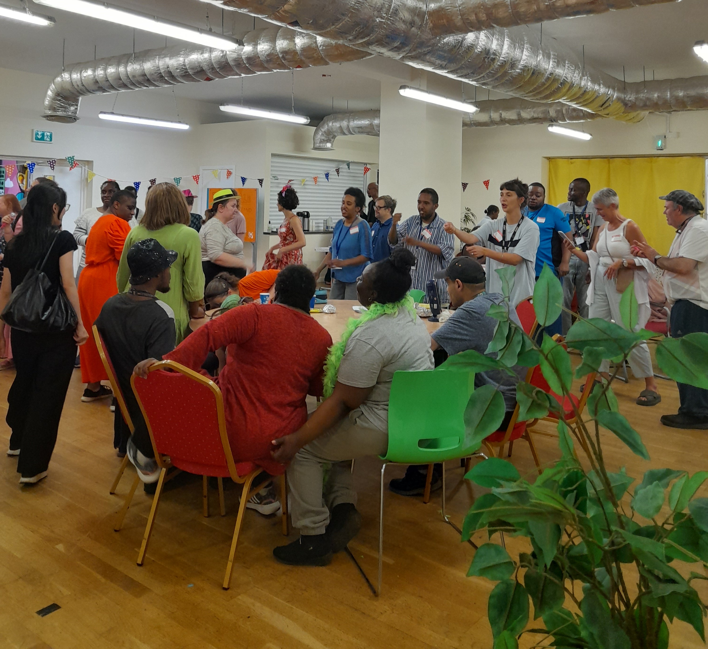 Room filled with people in colourful clothes