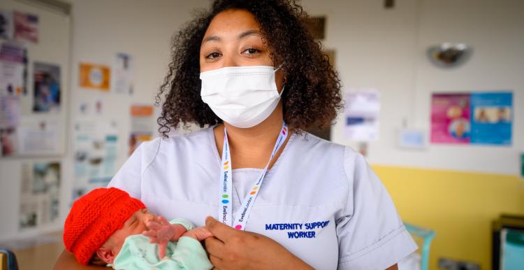 New born baby with maternity support worker
