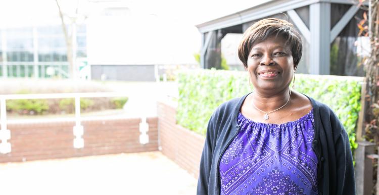 A woman having her photo taken outside a surgery