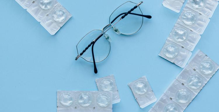 Photo of eyeglasses and contacts.