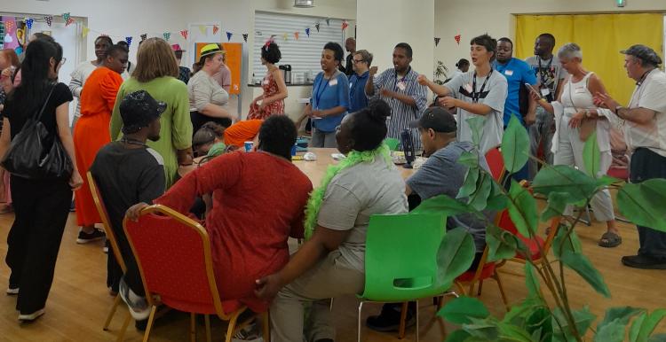 Room filled with people in colourful clothes