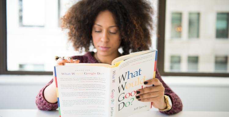 Woman sitting on a picnic blanket with her baby
