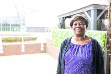 A woman having her photo taken outside a surgery