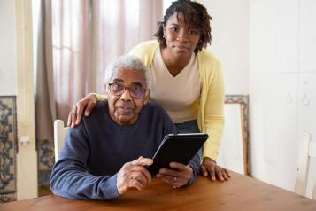 Black woman and older black man smiling