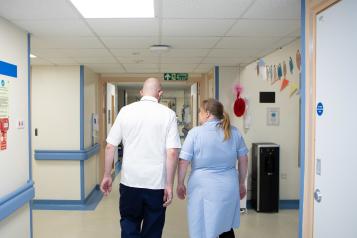 Two nurses walking in a hallway