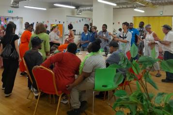 Room filled with people in colourful clothes