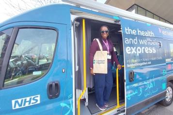Woman smiling on the Health and Wellbeing bus