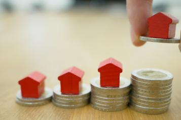 A photo of a person stacking money