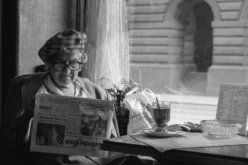an older lady sitting by herself at the window
