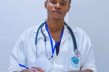 a black female doctor looking directly at the camera