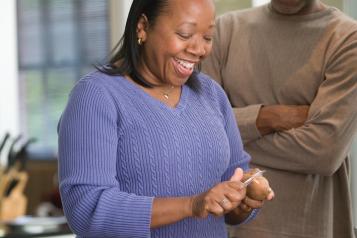BAME man and woman cooking together