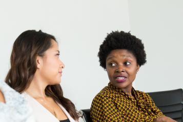 Two people talking in a waiting room