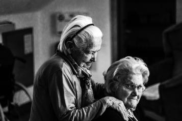 two old people caring for each other