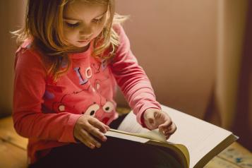 a child drawing in a book 