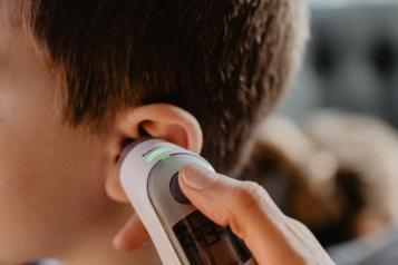 A young boy being checked by the doctor