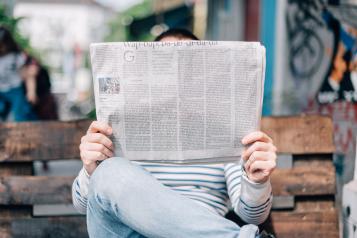 a man reading a newspaper