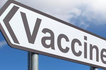 close up photo of a signpost that says "vaccine"