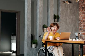 Women sitting in a wheel chair using a computer