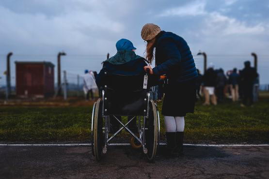 a young person next to an older person in a wheelchair