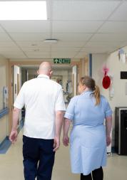 Two nurses walking in a hallway