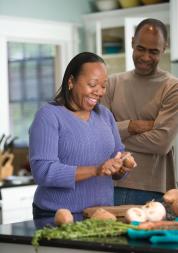 BAME man and woman cooking together