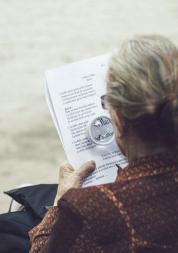 An older lady sitting on a bench