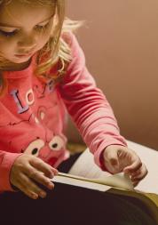 a child drawing in a book 