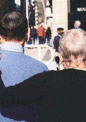 two people walking arm in arm 