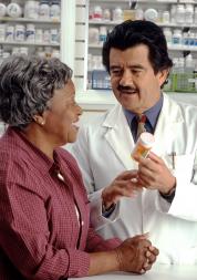 A lady speaking to the  pharmacist