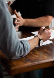 two people talking and filling out a survey