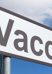 close up photo of a signpost that says "vaccine"